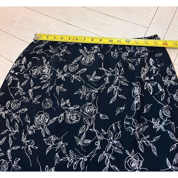 Floral print zip closure w/ elastic waist knee length skirt with ruffle trim. 12 - Picture 2 of 9